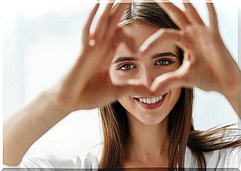 woman making a heart with her fingers