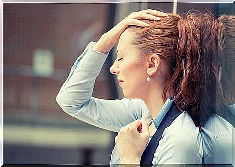 woman holding her head