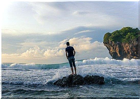 a man stands in the sea storms