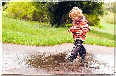 boy jumping on a puddle