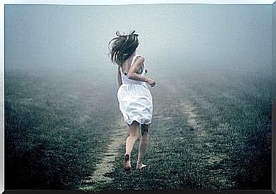 The woman is running in the fog