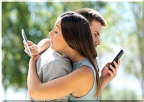 girl and boy hug phones in hand