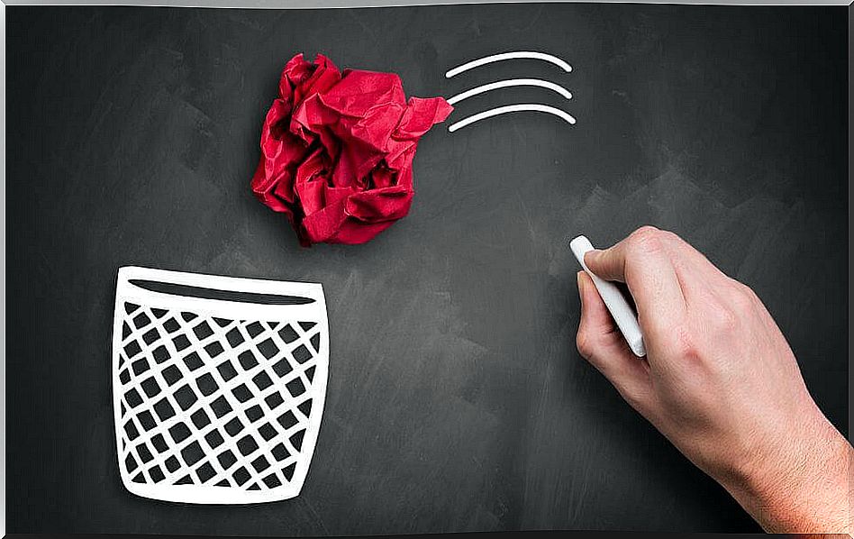 Red paper ball on a blackboard