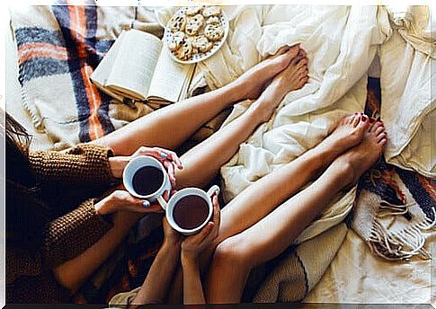 friends drinking tea in bed