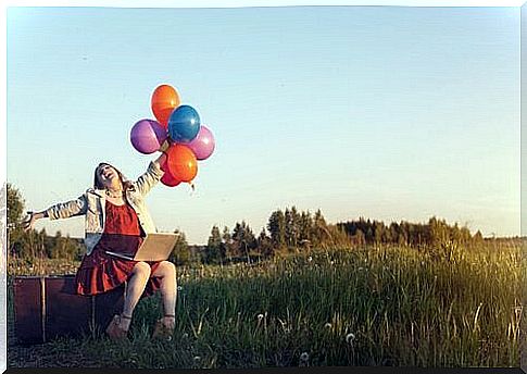 happy woman with balloons in hand