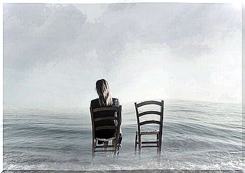 A woman is sitting in a chair in the water