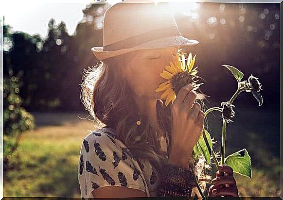 woman smelling a flower