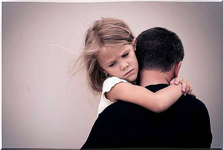 Dissatisfied girl in father's arms