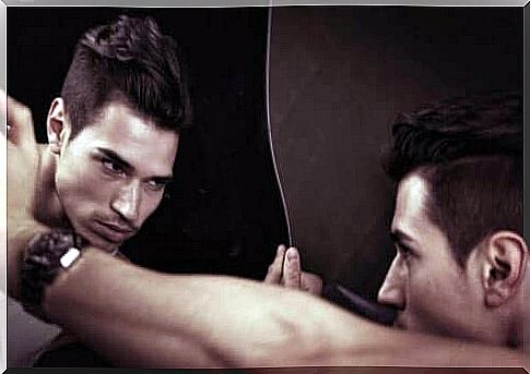 The man admires himself in the mirror.