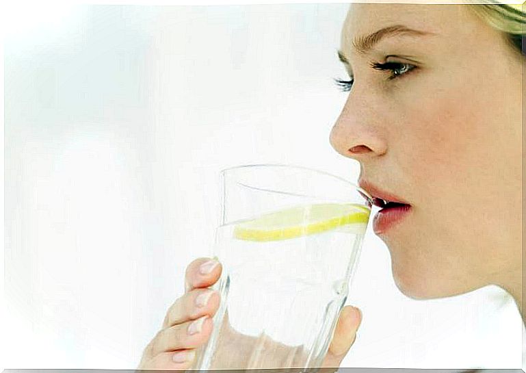 woman drinking lemon water