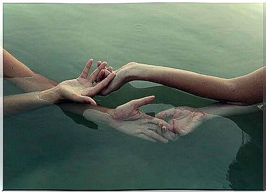 two hands in the water